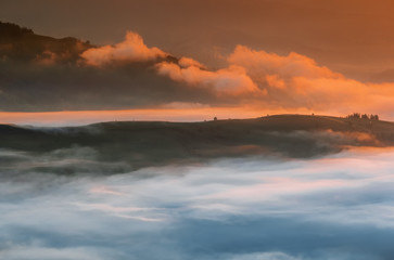 Fototapeta premium Carpathian Mountains. Mountains covered in mist at sunrise