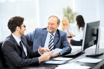Image of business partners discussing documents 