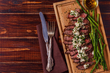 Steak with blue cheese sauce served with asparagus.