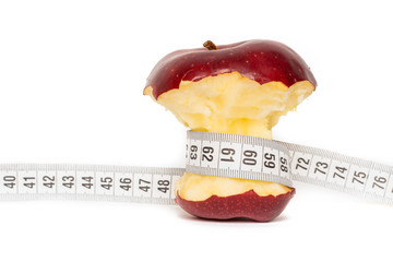 Red apple with measuring tape diet concept isolated on white background