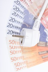 Concept of saving electricity at home. Euro banknotes and plug.