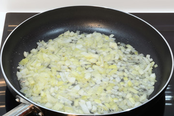 fried onions in a pan closeup