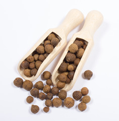 Grains of allspice isolated on white