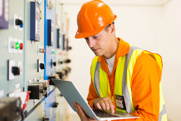 electrician working on laptop computer