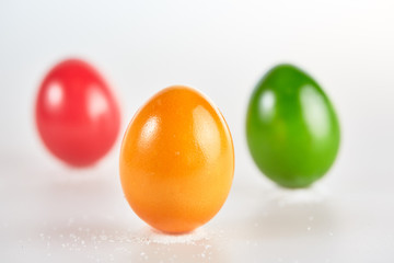 Three colored easter eggs on white background