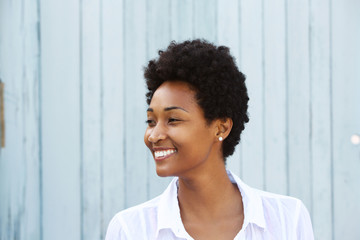 Happy young african woman looking away and smiling