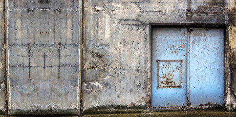 Old concrete building with blue doors