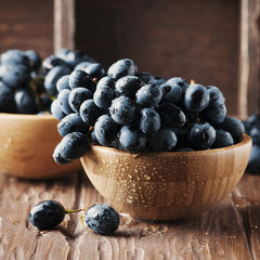 Fresh red grape on the wooden table