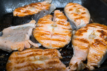 Preparing fish steaks on a pan-grill