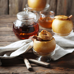 Baked apples with honey and cinnamon on the wooden table