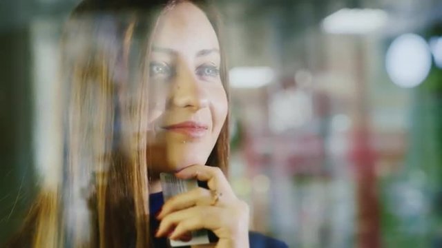 Waiting for shopping, handsome girl in shop window