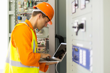 electrician working in power plant control room