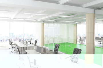Modern open space office with football field behind the transpar