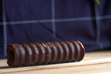Chocolate sweet rolles. Sweet chocolate biscuits, cookies lot to the table. Chocolate rolls with white stripes. Very tasty and sweet.