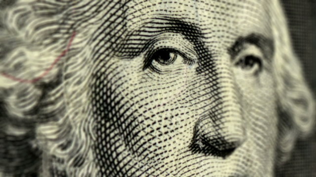 Cash 001: Stock video of presidents George Washington and Abraham Lincoln on one and five dollar bills (Loop).