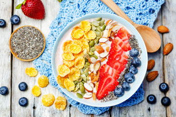 healthy strawberry smoothie bowl with fruits, cereals, seeds and