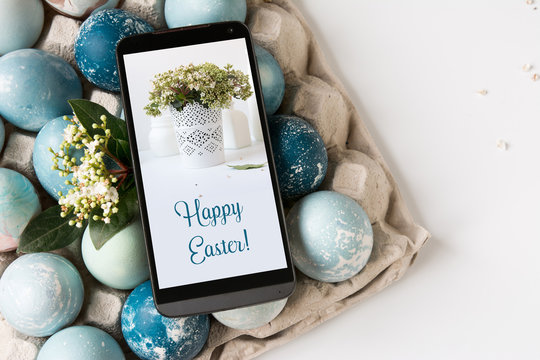  Mobile Easter card on the screen, decorative eggs on blue