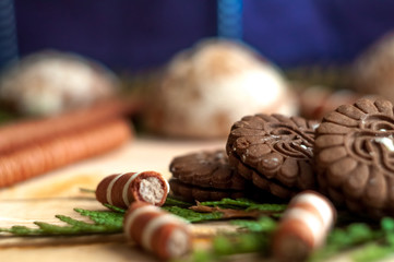 Sweet chocolate biscuits, cookies lot to the table. Chocolate rolls with white stripes. Very tasty and sweet.