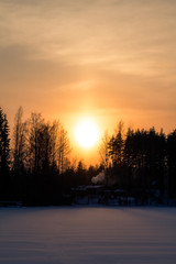 Orange sunset on the lake in Finland in the winter