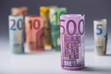 Several hundred euro banknotes stacked by value.Rolls Euro  banknotes.Euro currency money.Announced cancellation of five hundred euro banknotes. Banknotes stacked on each other in different positions