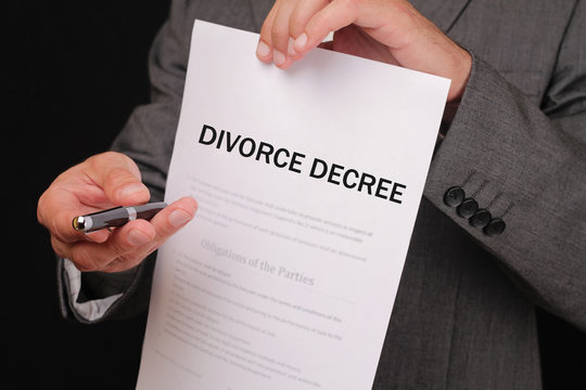 Divorce  concept. Man offering a pen to sign divorce decree close up.