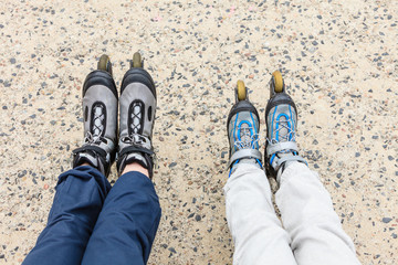 Closeup of people friends with roller skates.