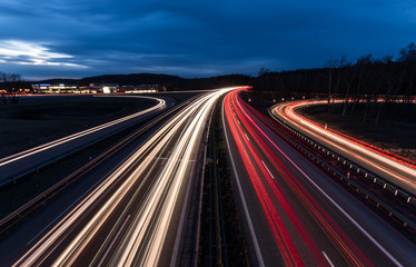 white and red car light trails on motorway junction - obrazy, fototapety, plakaty