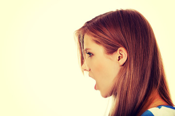 Angry young woman screaming for someone