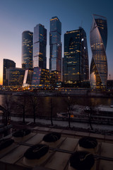 View on International Moscow City Business Center in the night from another side of the river on the embankment