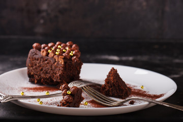 Piece of chocolate cake  on a dark background.selective focus.