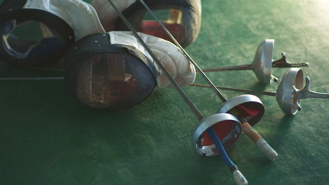 fencing mask and foil on the floor