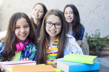   happy diligent girls looking at camera 