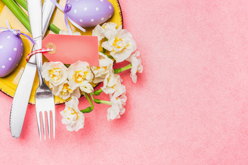 Easter table place setting on pink background, top view, place for text.