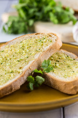 Garlic bread with parsley on rustic white table
