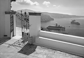Santorini - gate of little chapel under Skaros castle and cruises