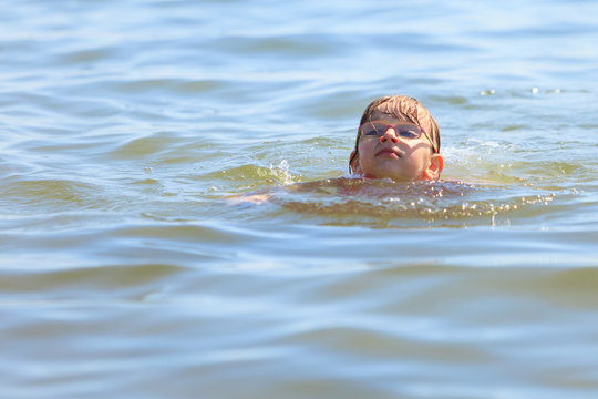 Little girl kid swimming in sea water. Fun