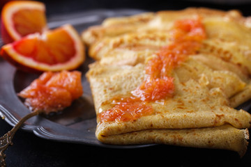 Pancakes with jam of red oranges.selective focus.