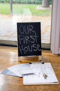 our first house sign with paint swatches and keys to new house