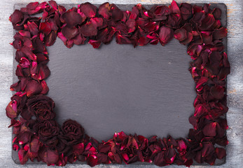Background of red rose petals ,on a black background.Valentine's day.Copy space.selective focus.