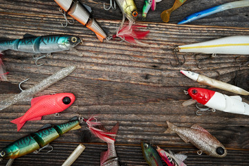 Fishing baits isolated on wooden background