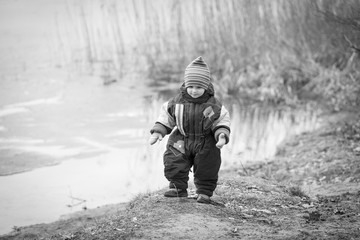 Little boy playing on lake shore