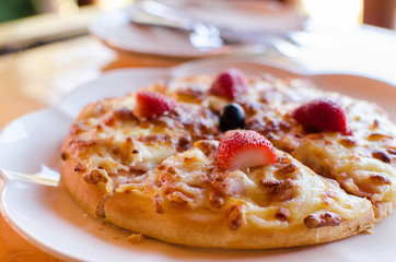 Delicious strawberry pizza on white plate