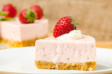Homemade strawberry cheesecake  on white plate