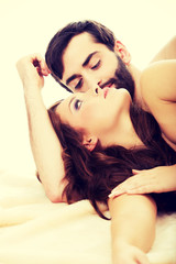 Naklejka premium Young loving couple in bed.