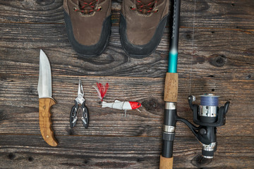 fishing tackles and fishing gear on wooden background