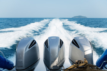 Three powerful engines mounted on the speedboat