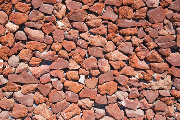 Santorini - Red pumice wall background