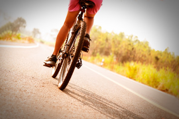 female mountain bike rider on public road