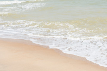 Fototapeta na wymiar green ocean wave with white sand for background