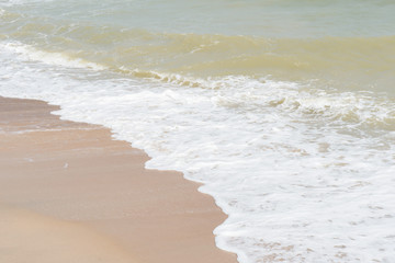 green ocean wave with white sand for background